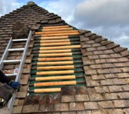 Opening sealed using breathable membrane, battens installed in preparation for the installation of tiles