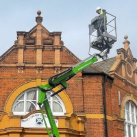 Using cherry picker to repair church roof