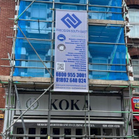 Scaffolding with banner for roofing work